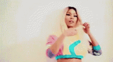 a woman in a crop top is holding a piece of paper in front of her face .