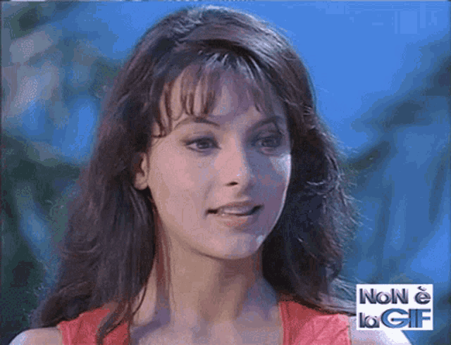 a close up of a woman 's face with the words non e la gif in the corner