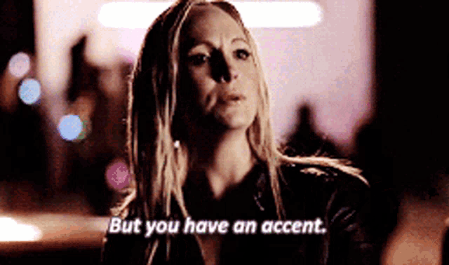 a woman says " but you have an accent " in front of a crowd