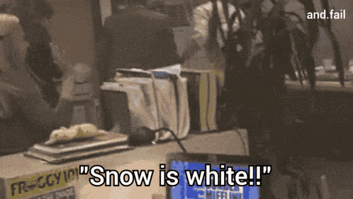 a sign that says " snow is white " is on a table