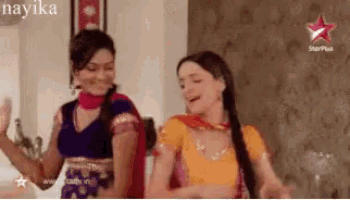two women are dancing in front of a starplus logo