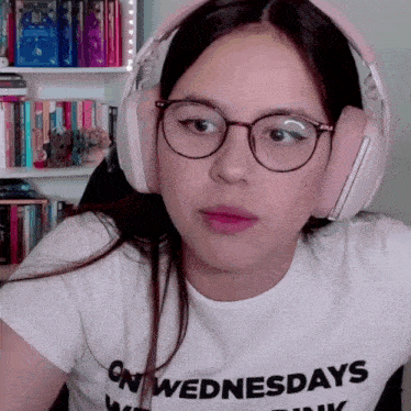 a girl wearing headphones and a white shirt that says on wednesdays