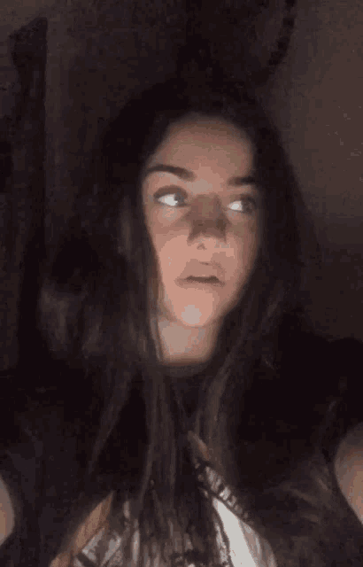 a girl with long hair is wearing a t-shirt that says ' a ' on it