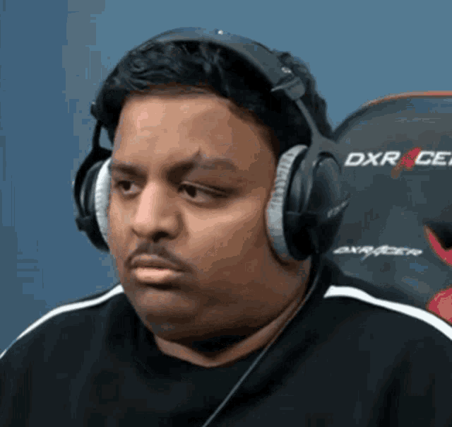 a man wearing headphones that say dxr on the back