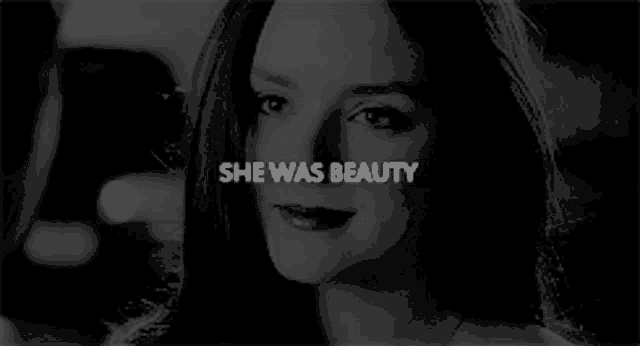 a black and white photo of a woman 's face with the words `` she was beauty '' written above her .