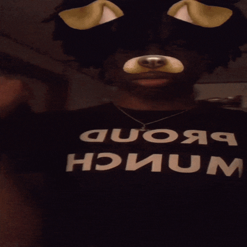a man wearing a black shirt that says " which " on it