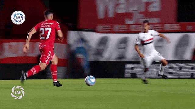 a soccer player in a red shirt with the number 27 on it