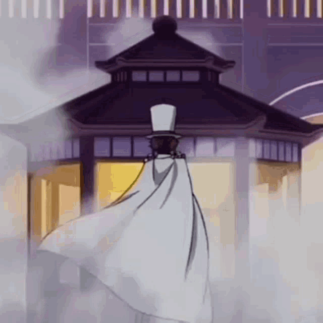 a man in a white cape and top hat is standing in front of a gazebo .