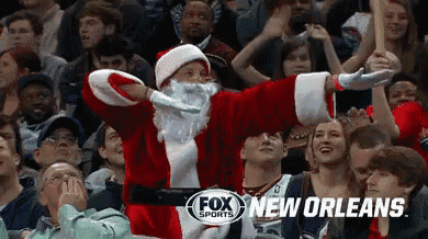 a man dressed as santa claus is in the crowd at a fox sports event