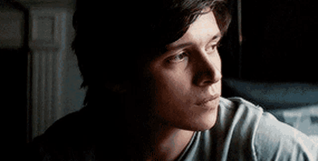 a close up of a man 's face looking out a window