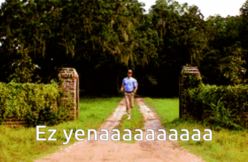 a man walking down a dirt road with the words ez yenaaa aa aa