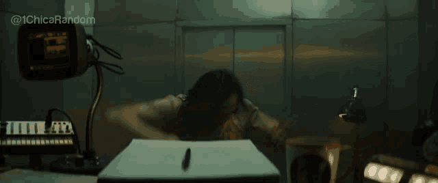 a woman sits at a desk in front of a monitor with the hashtag @ 1chica random