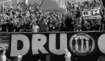 a crowd of people are standing in front of a banner that says drug