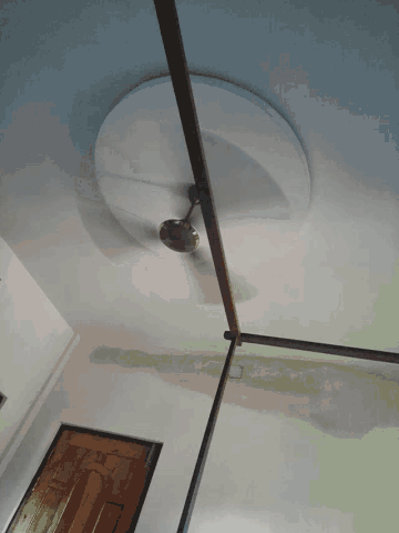 a ceiling fan is hanging from the ceiling above a doorway
