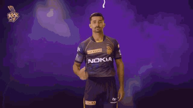 a man in a nokia jersey stands in front of a purple backdrop