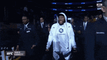 a man wearing a crypto.com hoodie walks out of a ufc event