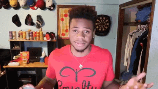 a man wearing a red shirt that says ' priority ' on it