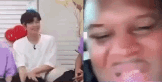 a man and a woman are sitting next to each other on a couch and making funny faces .