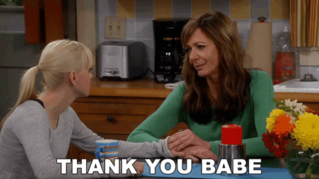 two women are sitting at a table with the words thank you babe written below them