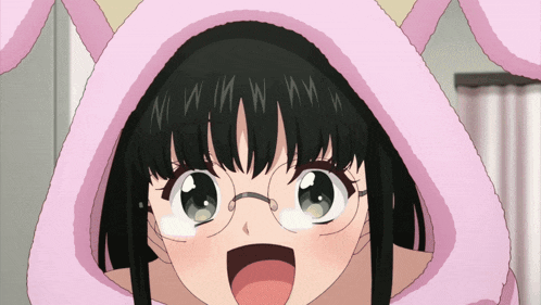 a girl with glasses is wearing a pink hood with bunny ears