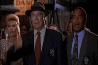 a group of men in suits and ties are standing next to each other in front of a crowd .