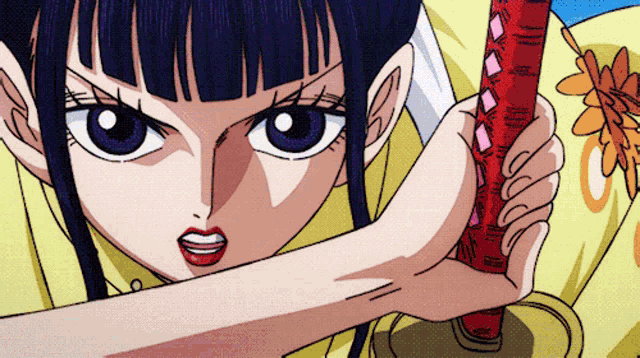 a close up of a girl holding a sword with a red handle