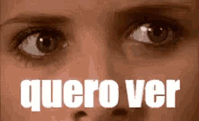 a close up of a woman 's eyes with the words quero ver written in white letters .