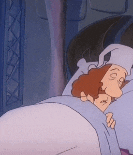 a cartoon character is sleeping in a bed