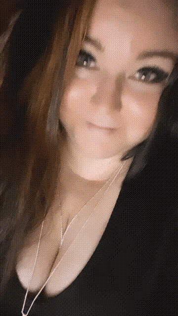 a close up of a woman 's face with a black shirt on