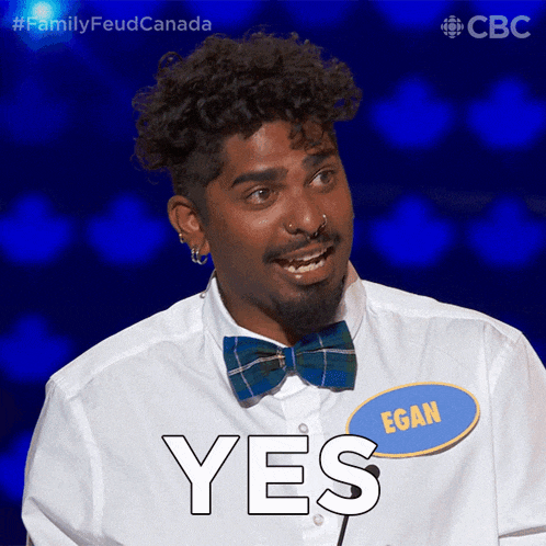 a man wearing a bow tie and a name tag that says egan says yes