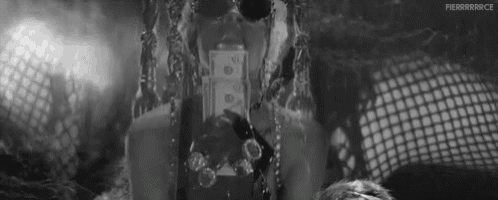 a black and white photo of a person holding a dollar bill