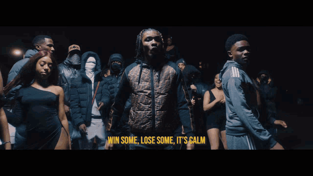 a man in a fendi jacket stands in front of a crowd with the words win some lose some it 's calm