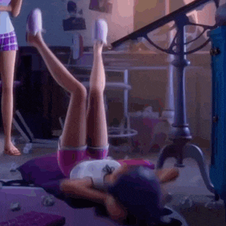 a girl is laying on her stomach on a bed with her legs up in the air .
