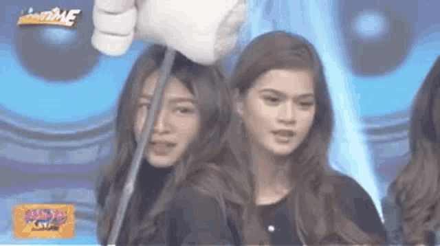 a group of women standing next to each other on a stage .
