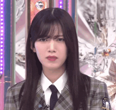 the girl is wearing a plaid suit and tie