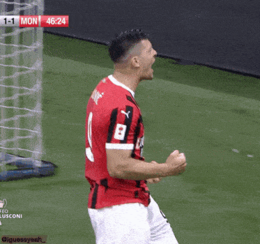 a soccer player with the number 8 on his jersey celebrates