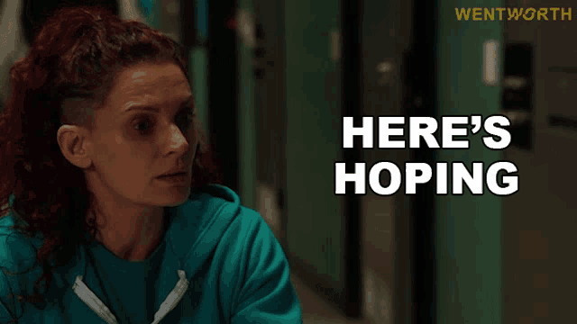 a woman in a blue sweatshirt says " here 's hoping "
