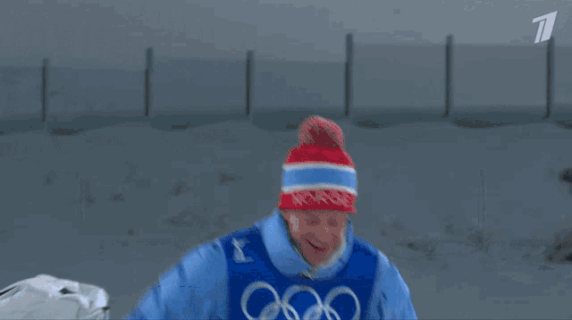 a man in a blue jacket with the word biathlon on his chest