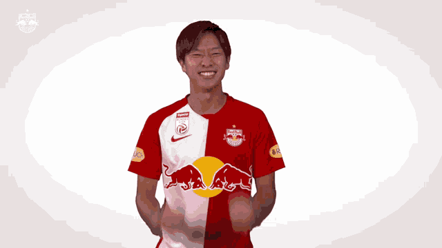 a man wearing a red and white jersey with a red bull on the front