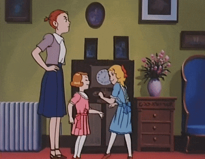 a woman is standing next to two little girls in a living room with a clock on the wall .