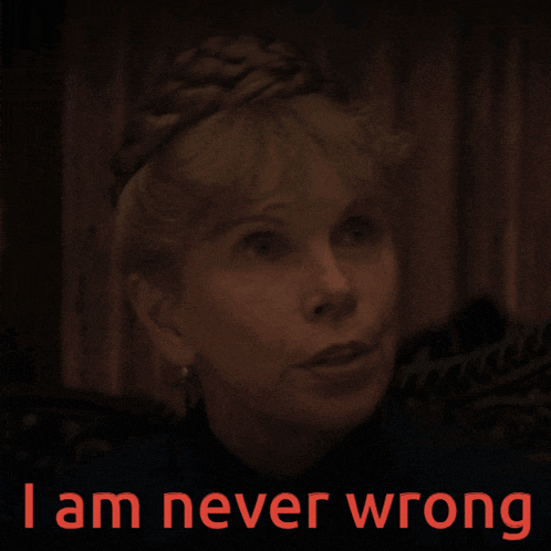 a woman in a dark room with the words " i am never wrong " on the bottom