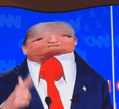 a man in a suit and tie is talking into a microphone with cnn in the background