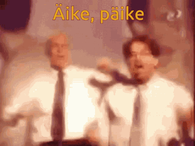 two men singing in front of microphones with the words " aike paike " in yellow