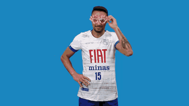 a soccer player wearing a fiat minas 15 jersey