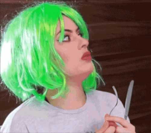 a woman with neon green hair is holding a knife and fork