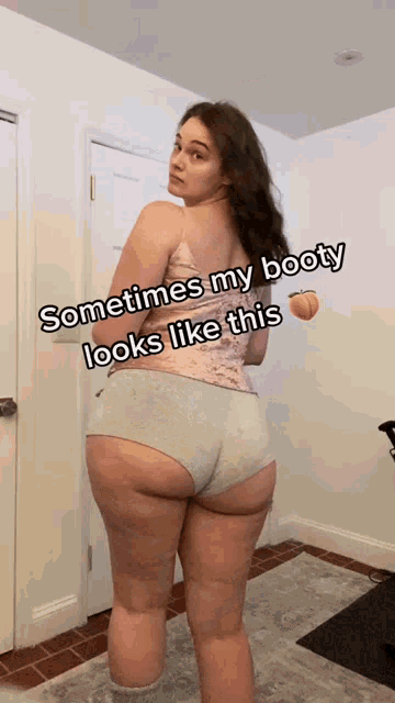 a woman is standing in front of a door with the caption sometimes my booty looks like this