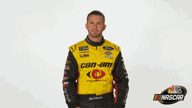 a man is wearing a yellow can-am racing jacket