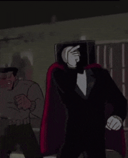a man in a tuxedo is pointing at another man in a cape while holding a sword .