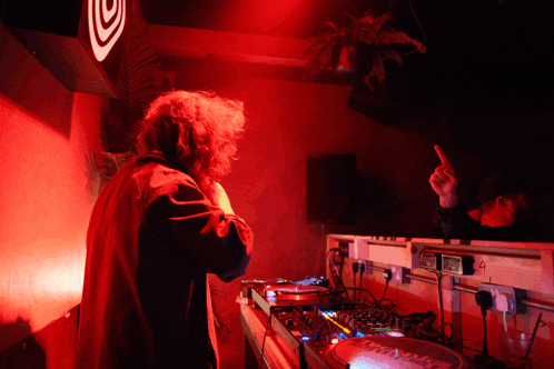 a person playing a dj set with a record labeled pioneer