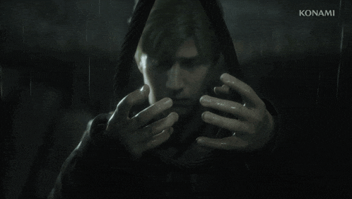 a man in a hooded jacket with konami on the bottom right
